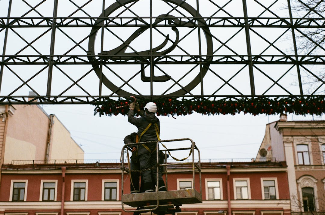 Construction worker adjusting hard hat during seasonal weather transition outdoors