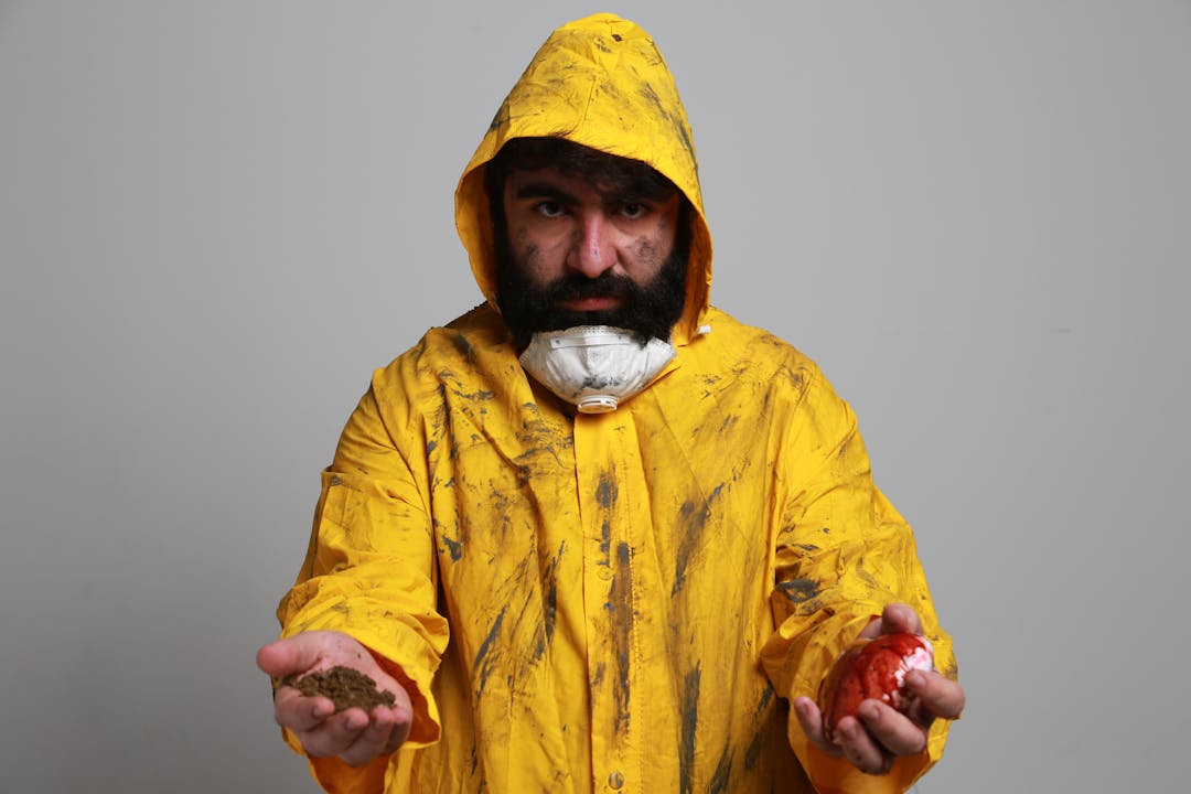 Environmental cleanup workers in protective gear testing contaminated industrial soil samples