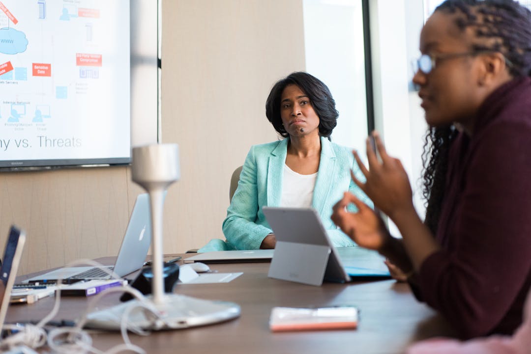 Middle manager engaged in authentic conversation with team member in office setting