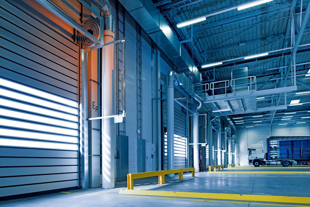 Modern warehouse loading dock with industrial equipment and operational activity