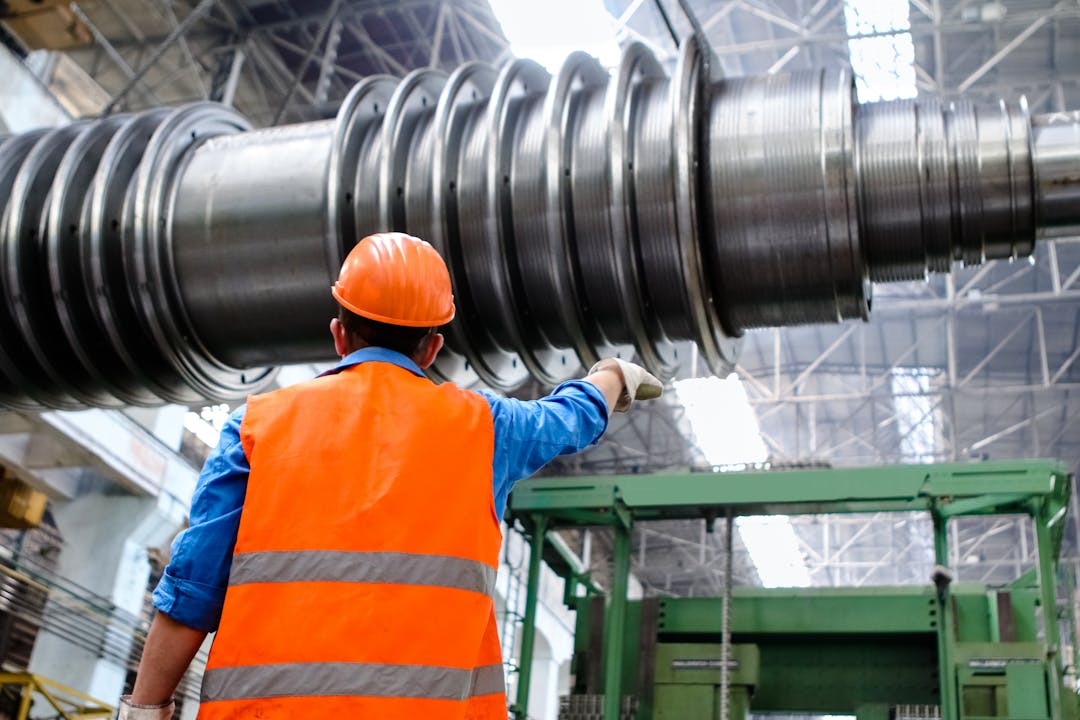 Technician performing preventive maintenance on industrial equipment in a facility