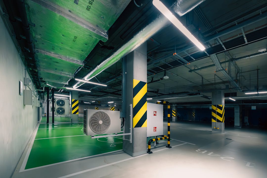 Parking lot with visible cracking and deteriorated asphalt showing deferred maintenance and wear