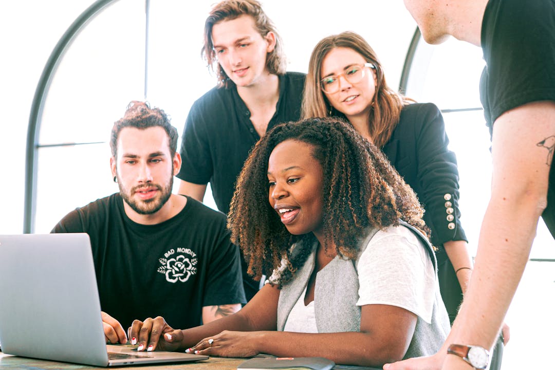 Business team collaborating across table during deal negotiation