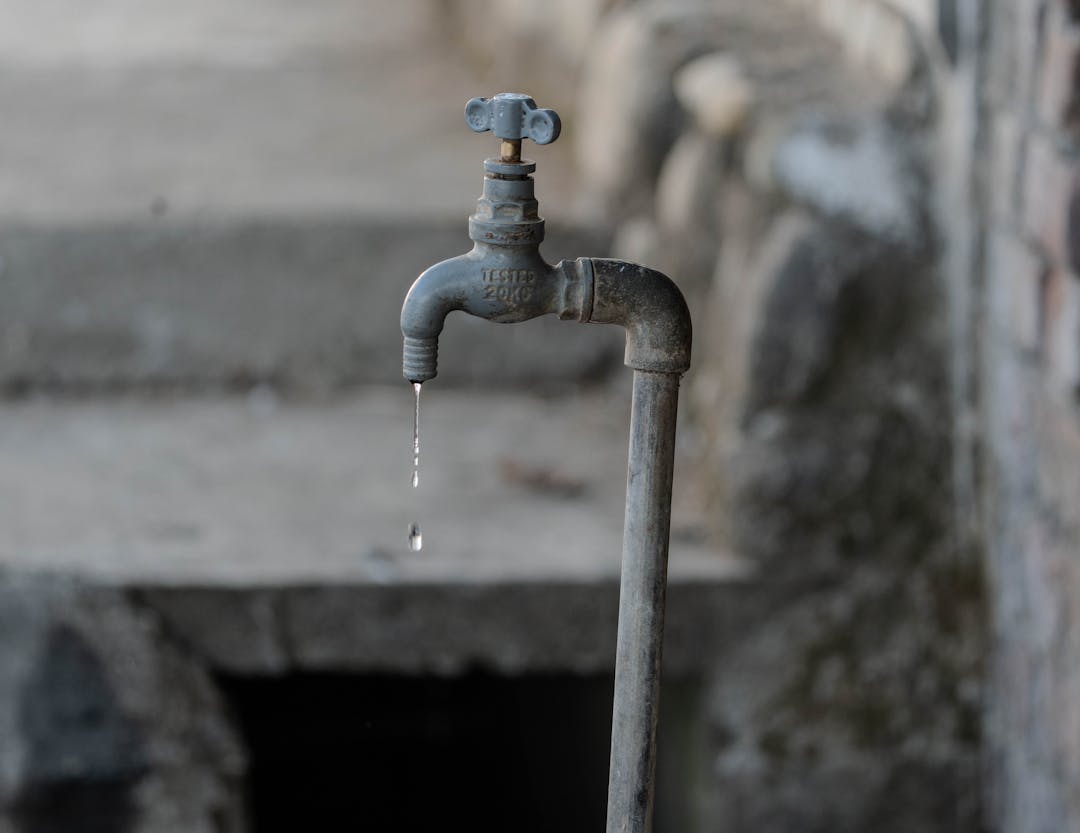 Professional examining unexpected water leak representing hidden revenue loss discovery