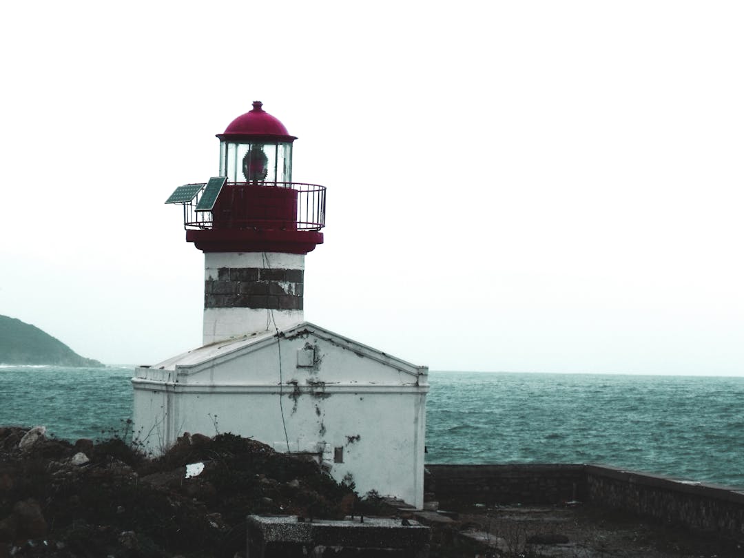 Lighthouse beacon cutting through fog providing guidance and safety for business owners