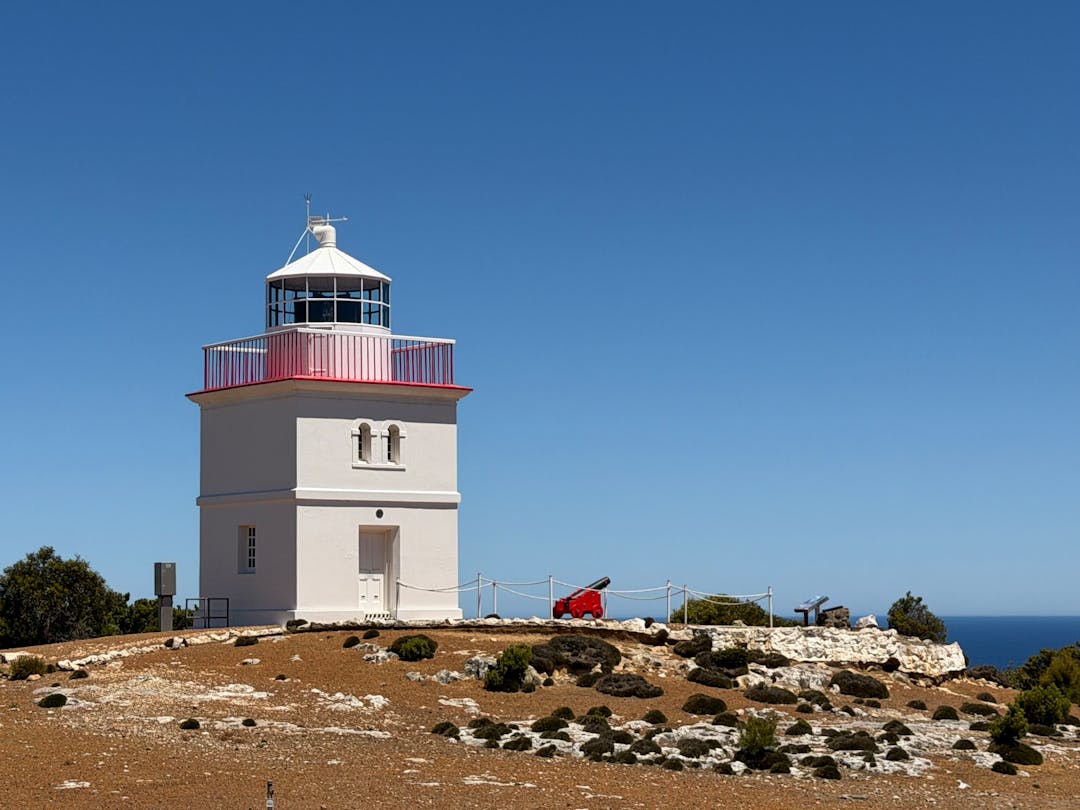 Lighthouse beam cutting through fog symbolizing clear communication signals reaching distant points