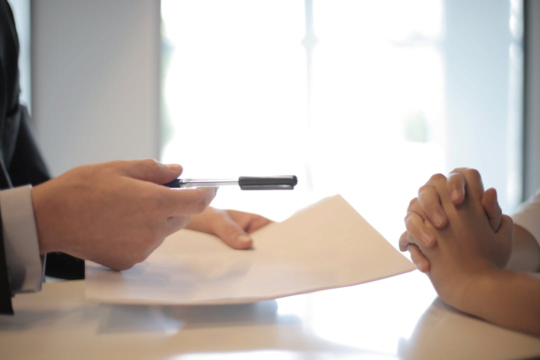 Stack of loan and financing documents with terms and conditions ready for review and signing