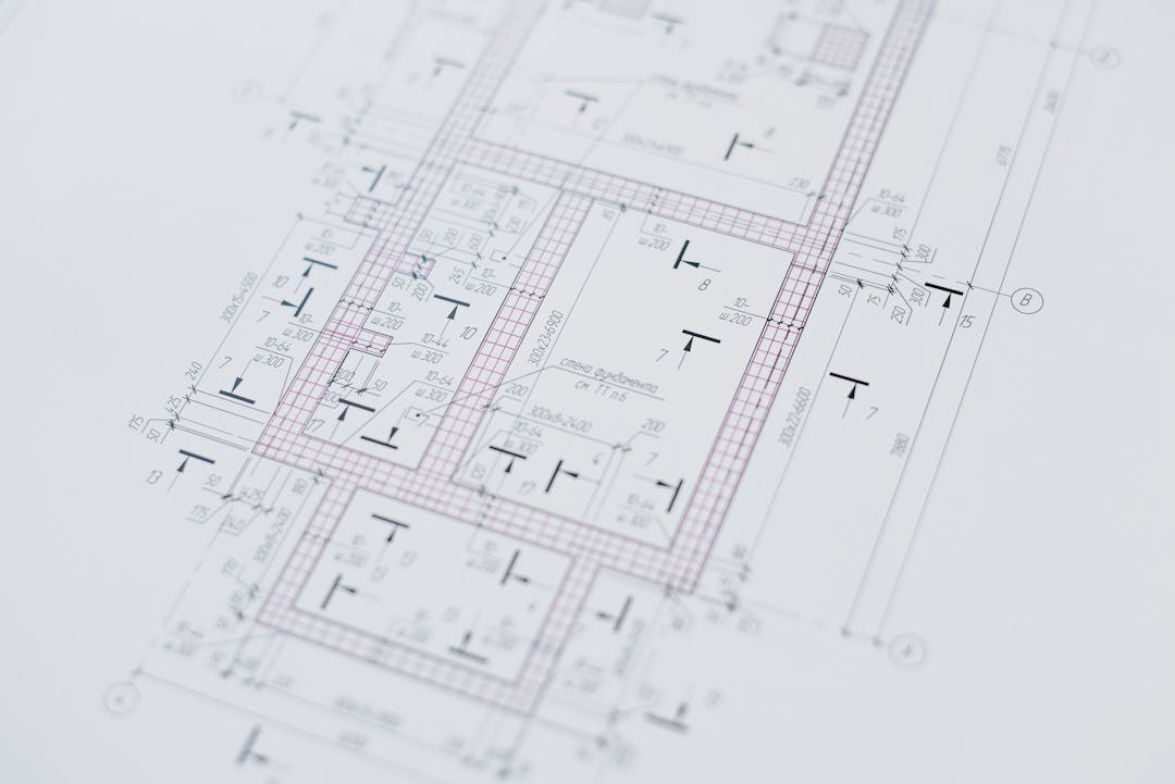 Blueprints and technical drawings laid out on a table
