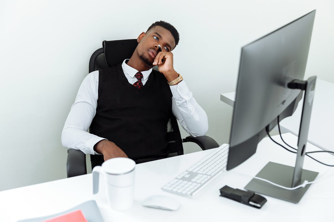 Business owner taking an important acquisition call at desk with papers