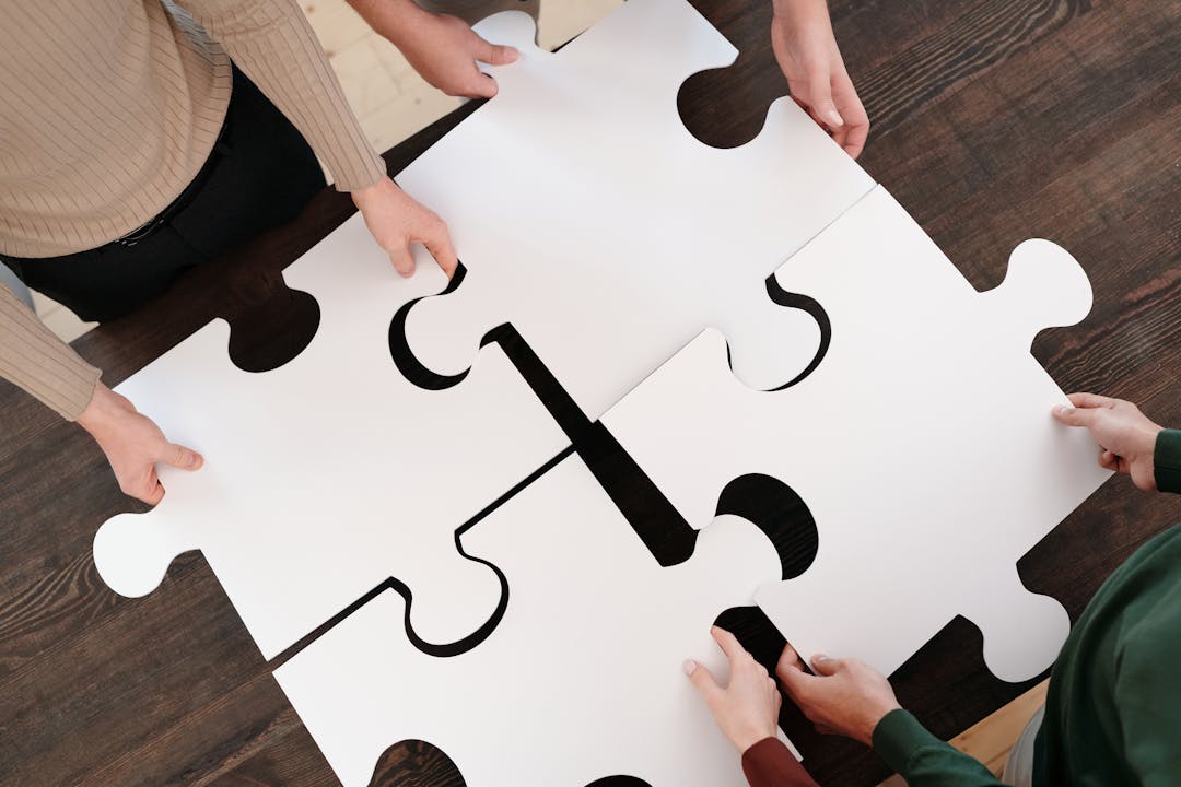 Multiple puzzle pieces connecting together representing business platform consolidation