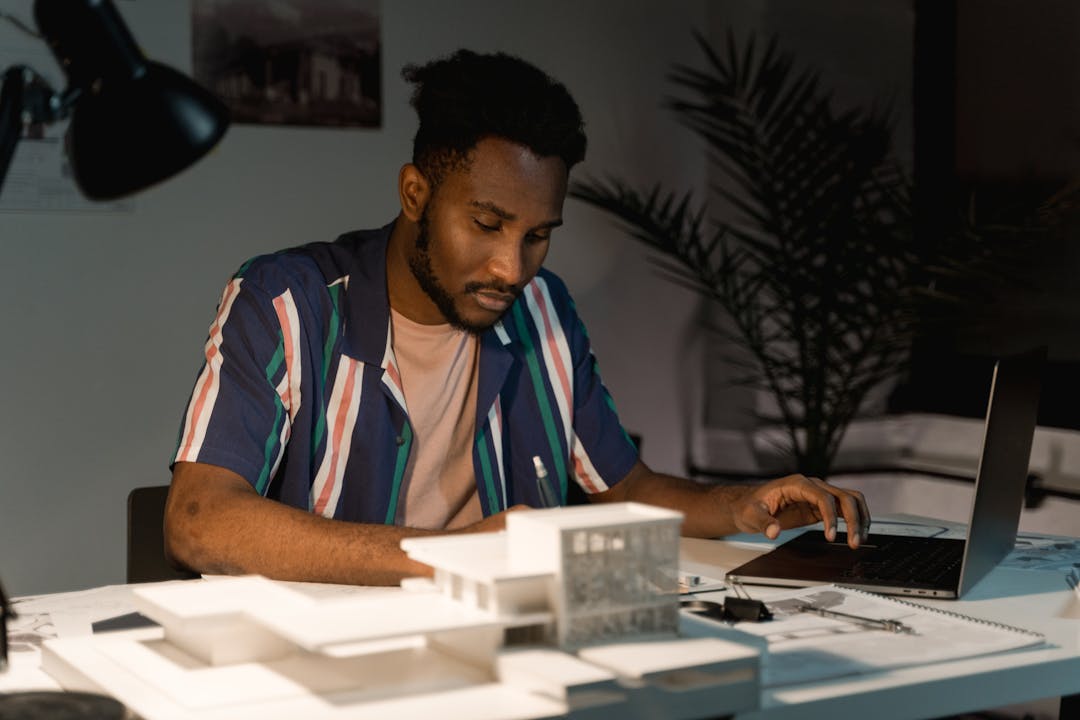 Founder sitting alone at desk with documents, representing concentrated decision-making burden