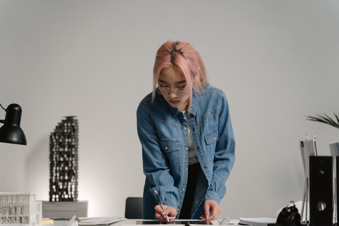 Individual focused intently on computer work at desk, symbolizing concentrated knowledge dependency