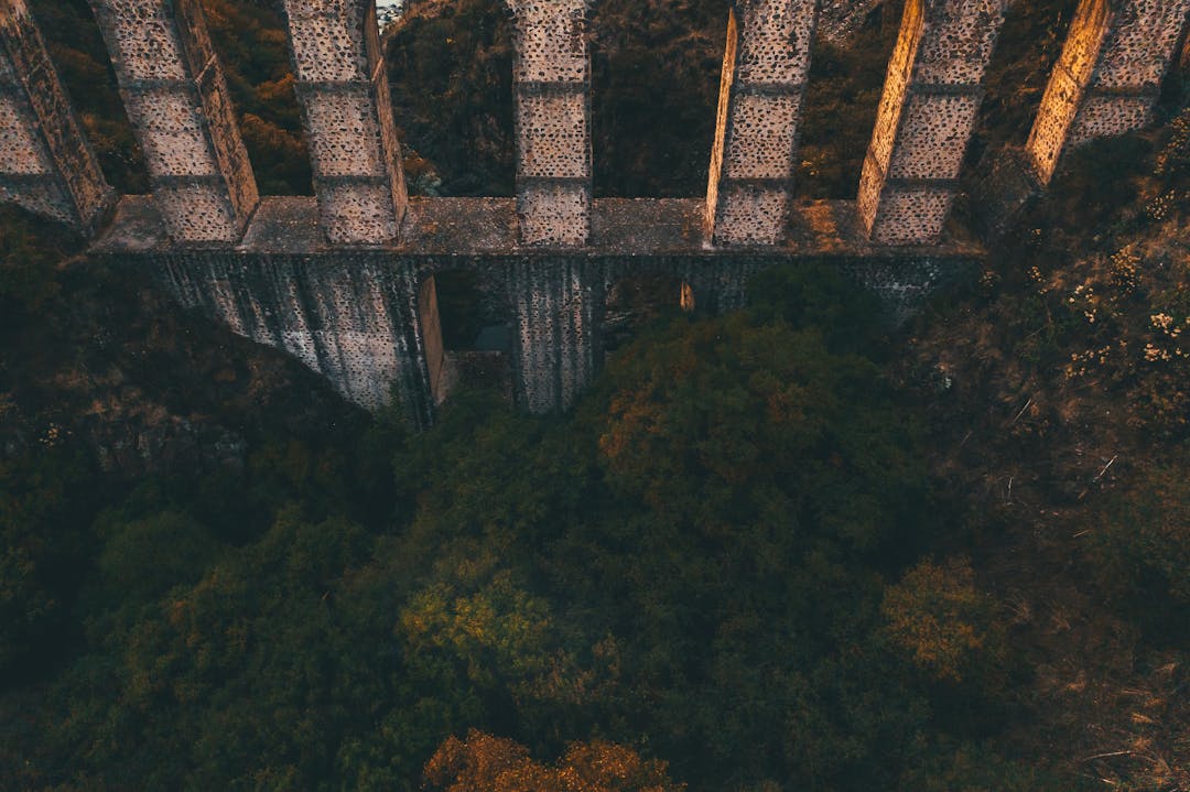 Wooden bridge spanning mountain gap, symbolizing overcoming competitive capability gaps