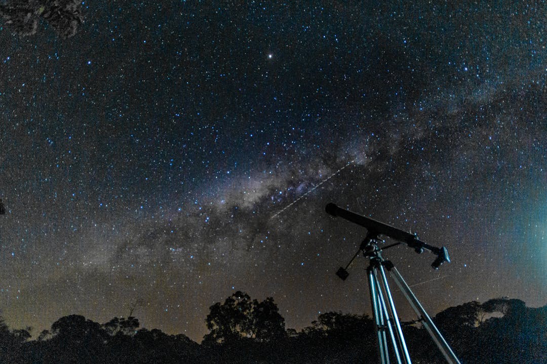 Telescope on a tripod pointed toward the horizon