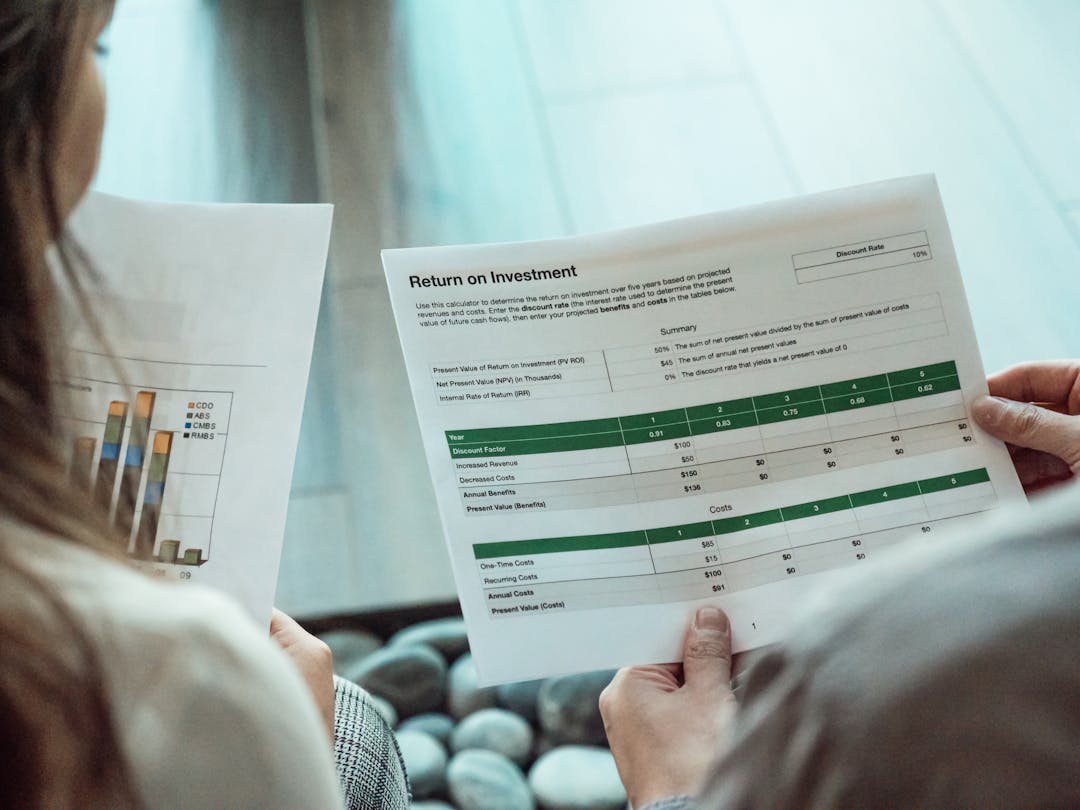Financial analyst reviewing budget spreadsheet and ROI calculations carefully