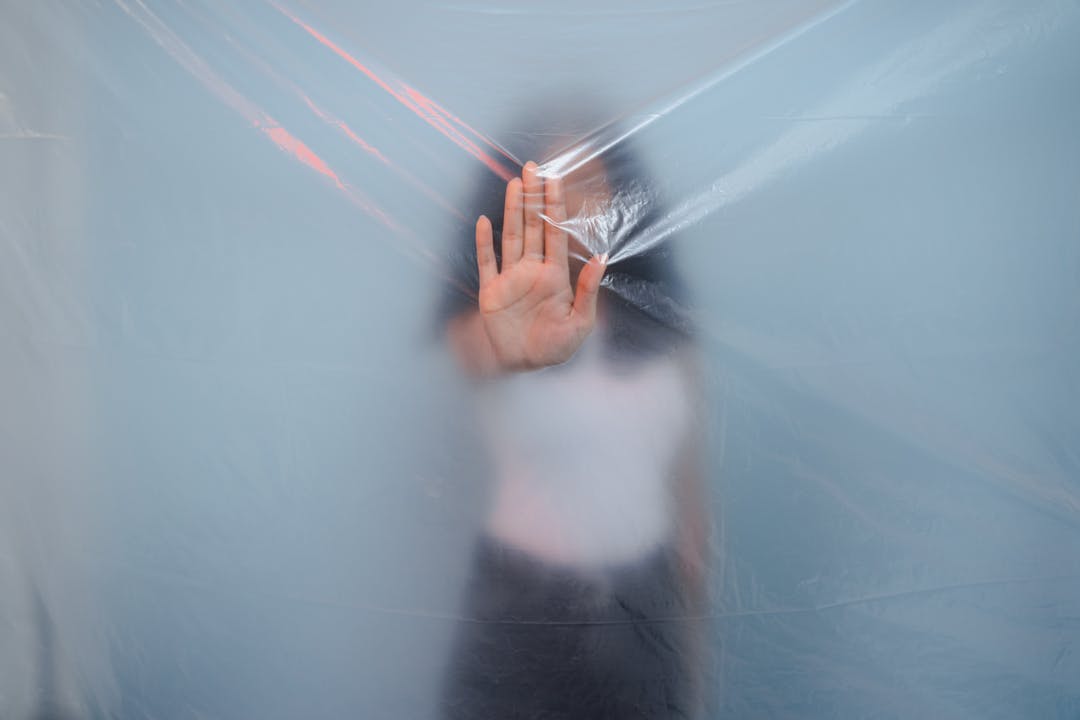 Metal shield with protective coating against dark background