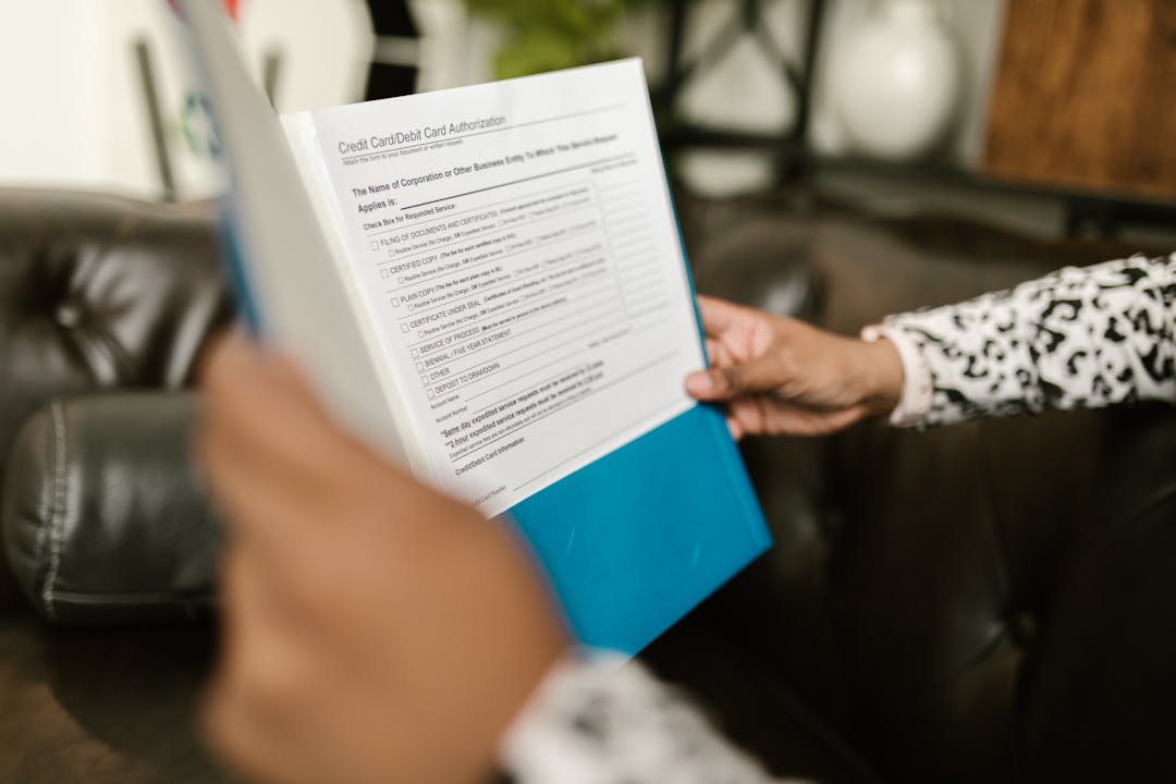 Close-up of hands reviewing financial spreadsheets and documents during business analysis
