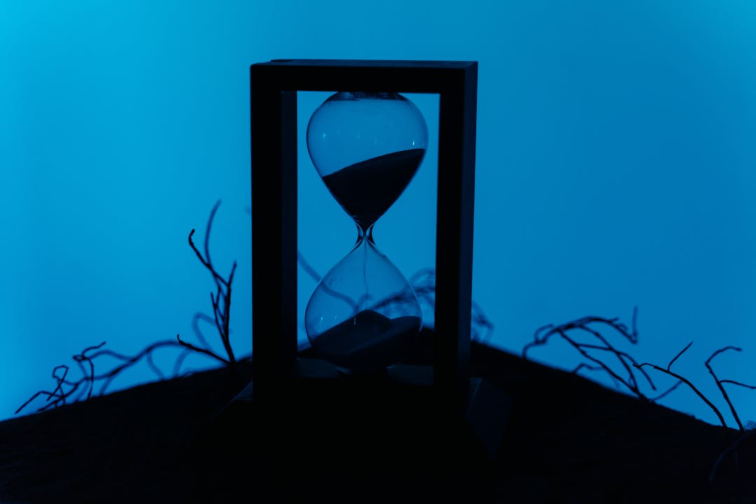 Sand flowing through hourglass representing the value of strategic timing