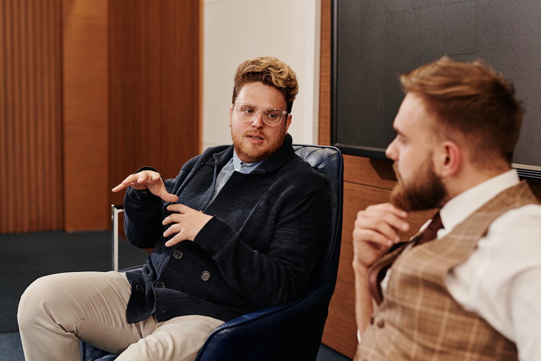 Team member confidently presenting to colleagues, showing developed capability and expertise demonstration