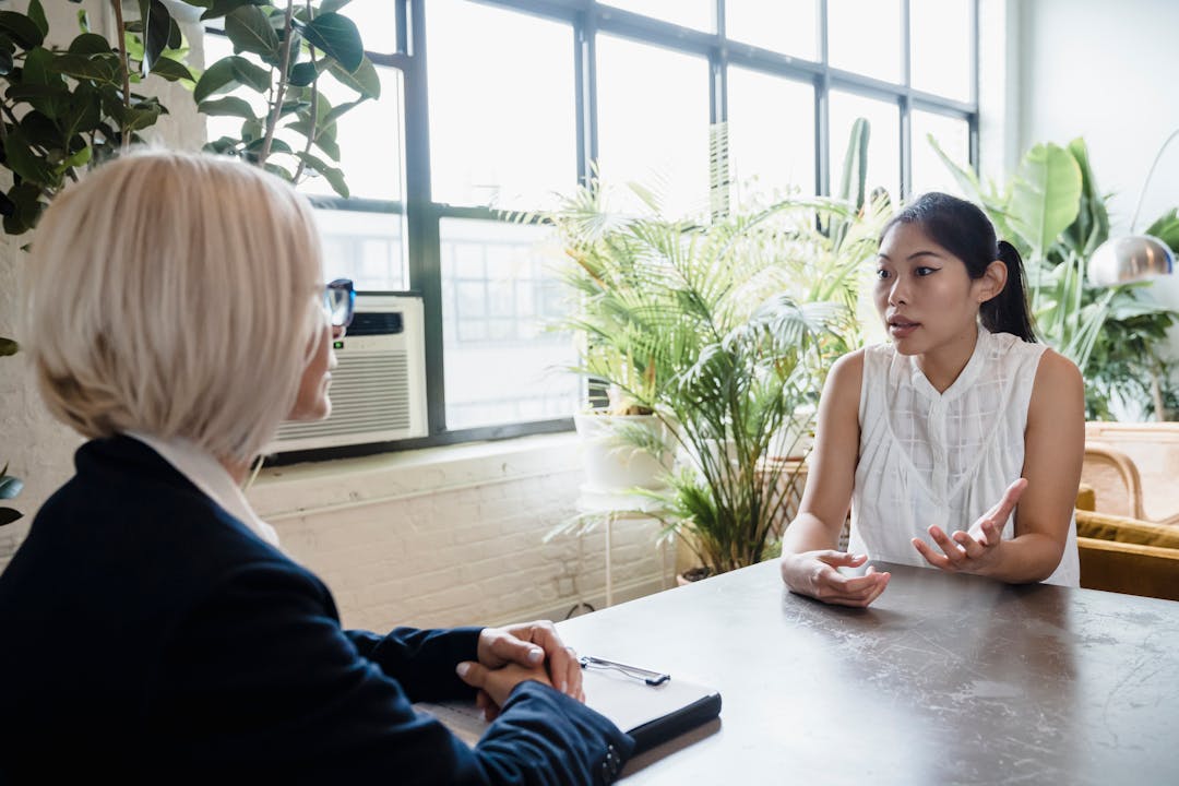 Two people engaged in serious business conversation across table