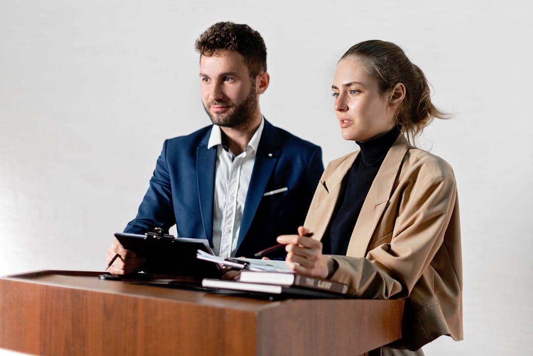 Team of employees looking concerned during workplace announcement meeting