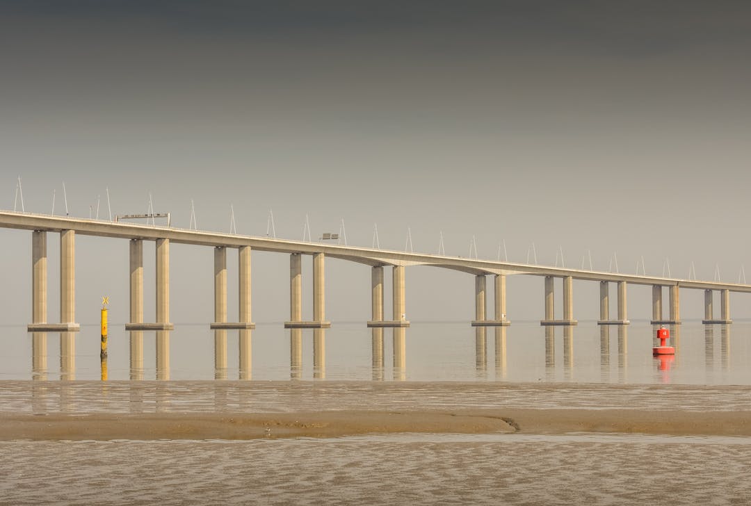 Stone bridge crossing a misty valley representing bridging valuation gaps in business deals