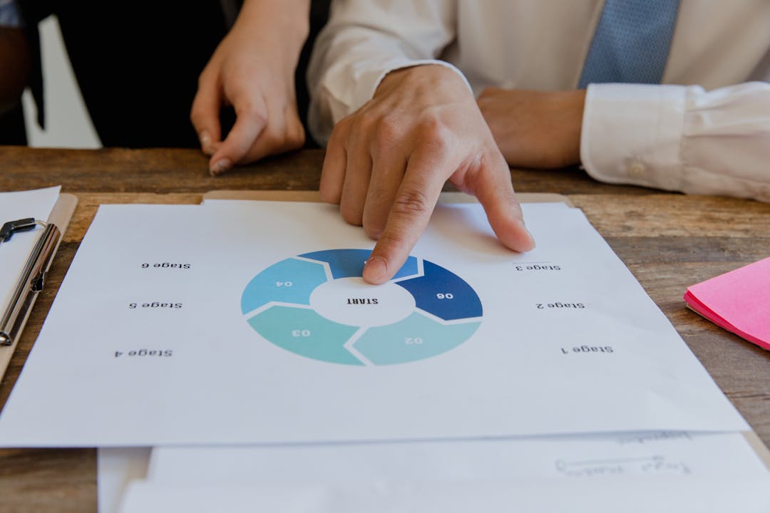 Manager examining organized process documentation and workflow materials at desk
