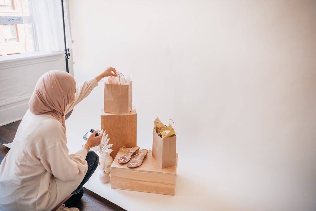 Hand checking off completed items on detailed business action plan checklist