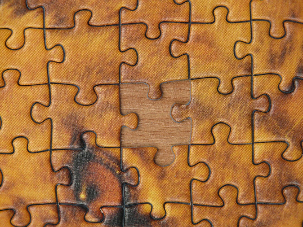 Jigsaw puzzle with several missing pieces creating visible gaps in complete picture