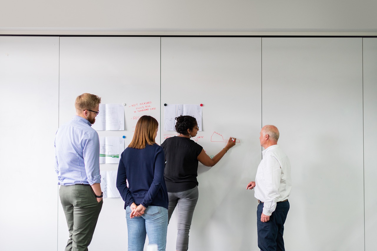 Team of professionals engaged in strategic discussion around conference table
