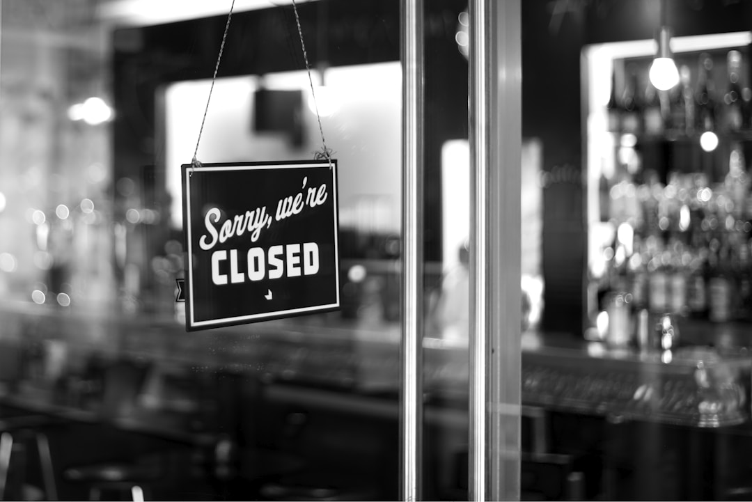 Business owner pausing to reflect deeply on a significant decision with serious expression