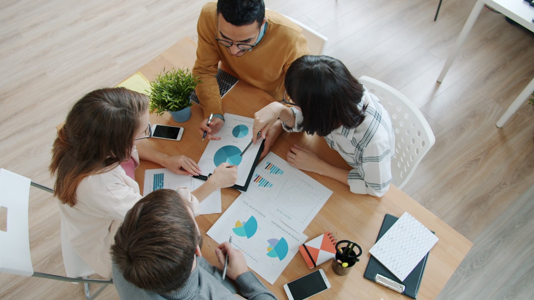 Leadership team engaged in strategic discussion around table, showing collaborative decision-making