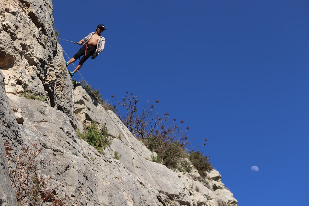 Mountain climber with safety rope representing risk protection and security measures
