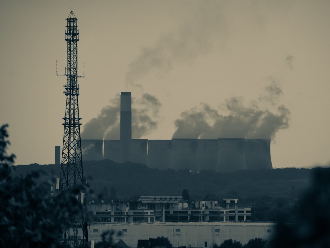 Manufacturing facility with visible emissions representing scope 1 and 2 carbon footprint