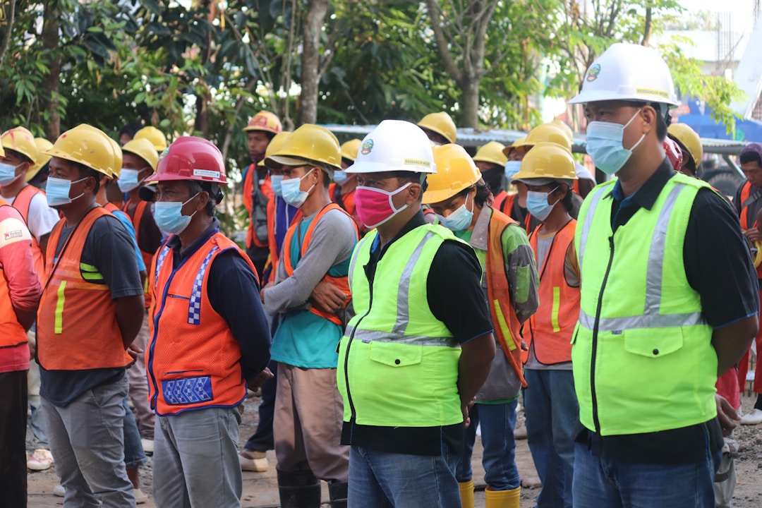 Construction workers reviewing project plans and equipment on active job site