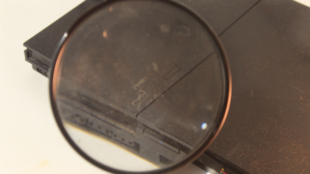 Close-up of magnifying glass examining detailed financial charts and employee data