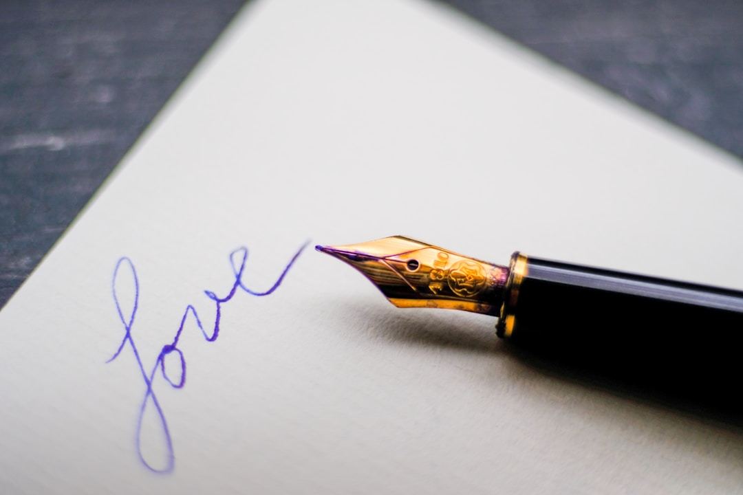 Close-up of pen signing important legal document with focused lighting