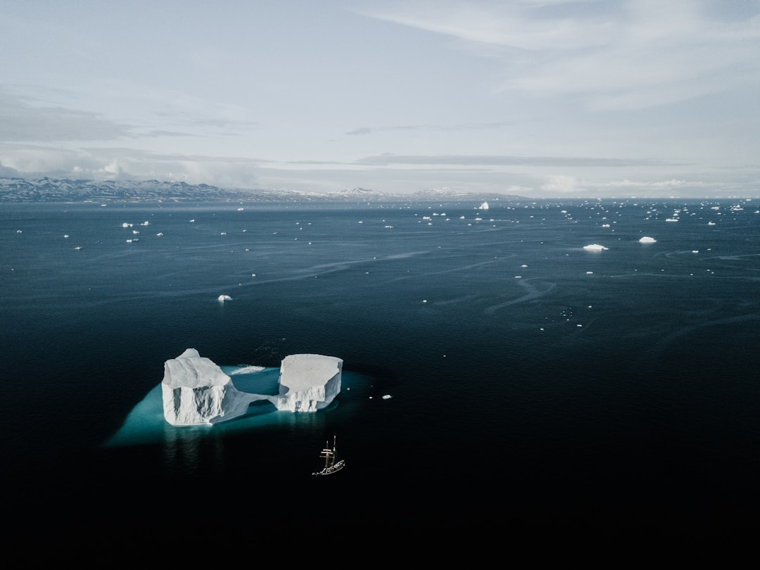Iceberg showing small visible portion above water with massive hidden structure below
