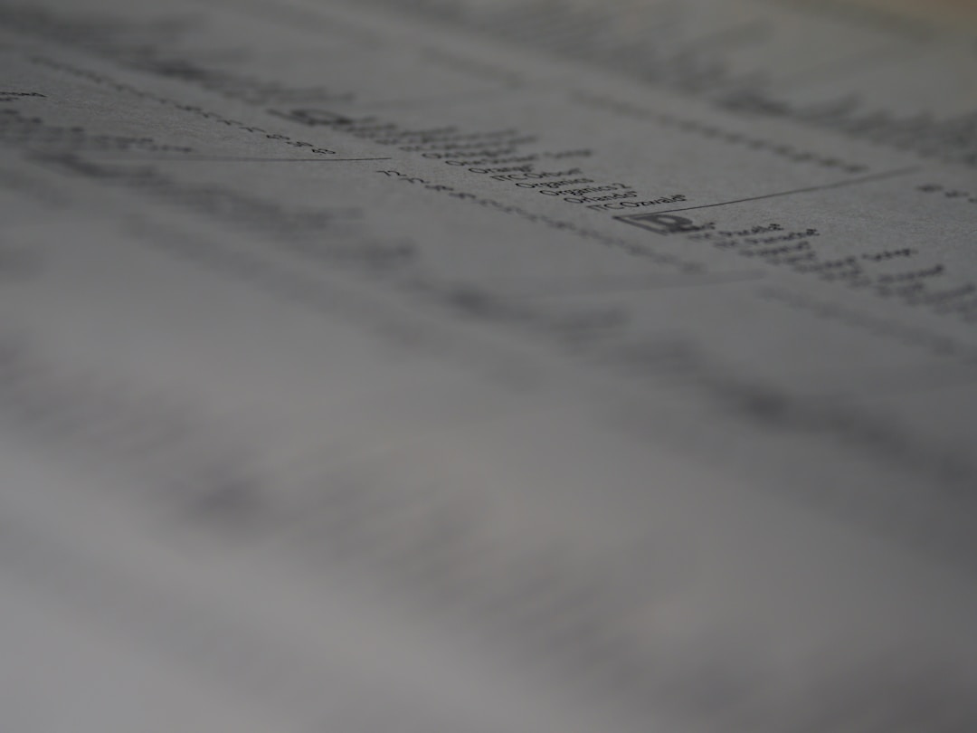 Business analyst looking surprised while reviewing financial spreadsheet data on computer screen