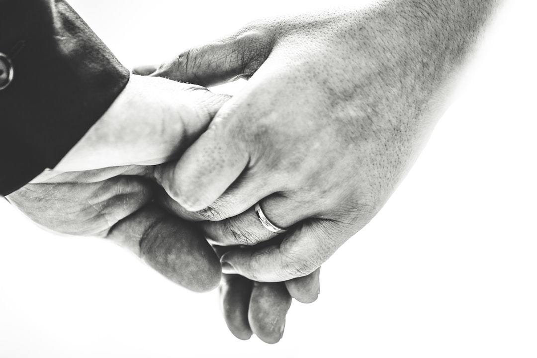 Two people reaching across gap showing trust and connection during transition