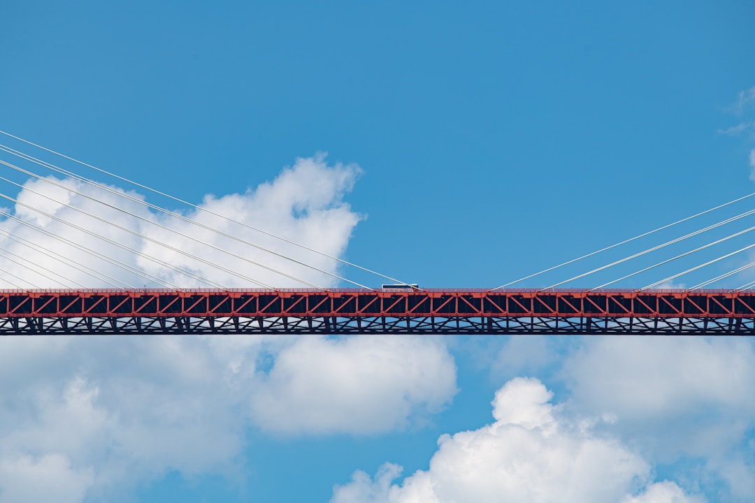 Elegant bridge spanning across misty valley connecting two sides representing successful business transformation