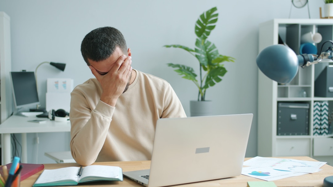 Individual with concerned expression reviewing unexpected financial statements or bills