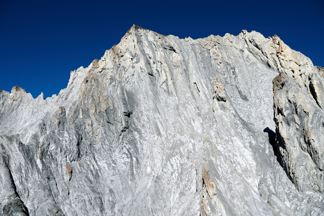 Person reaching mountain peak symbolizing successful completion of environmental preparation process