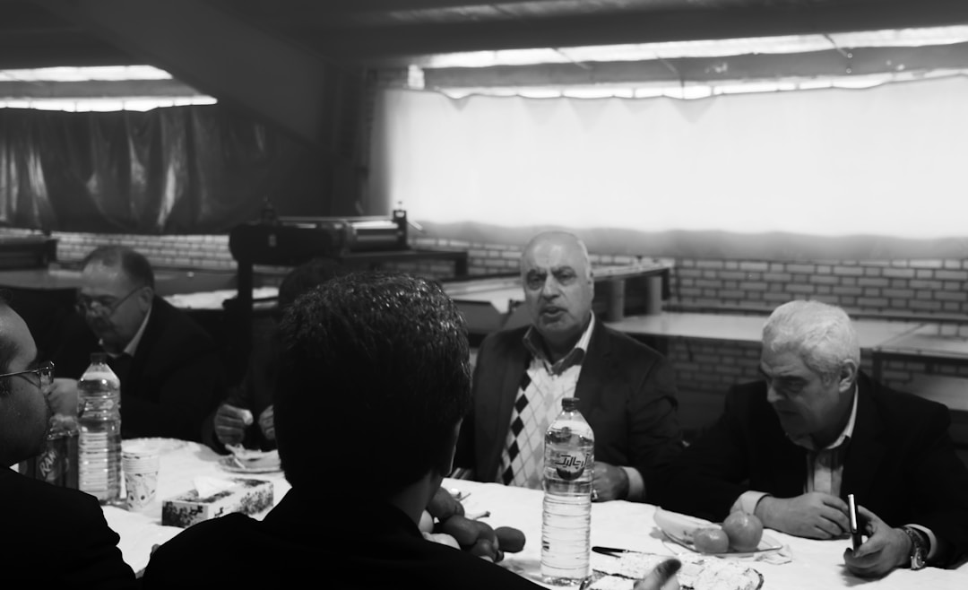 Professional team conducting relationship assessment meeting with customer account documentation