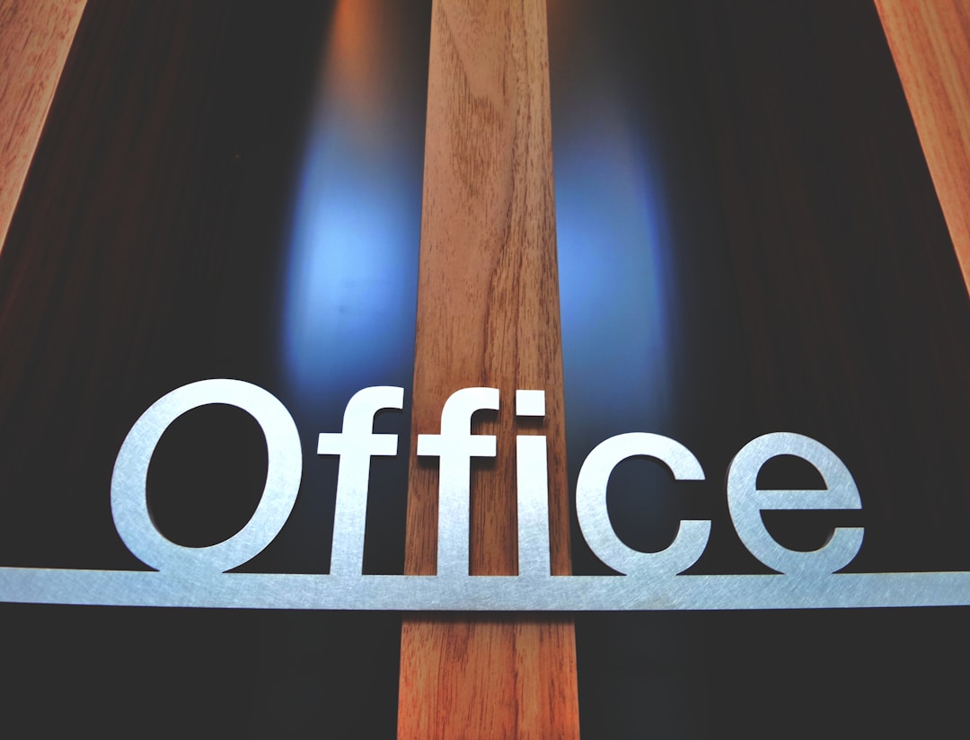 Established business owner in professional workspace reflecting on legacy