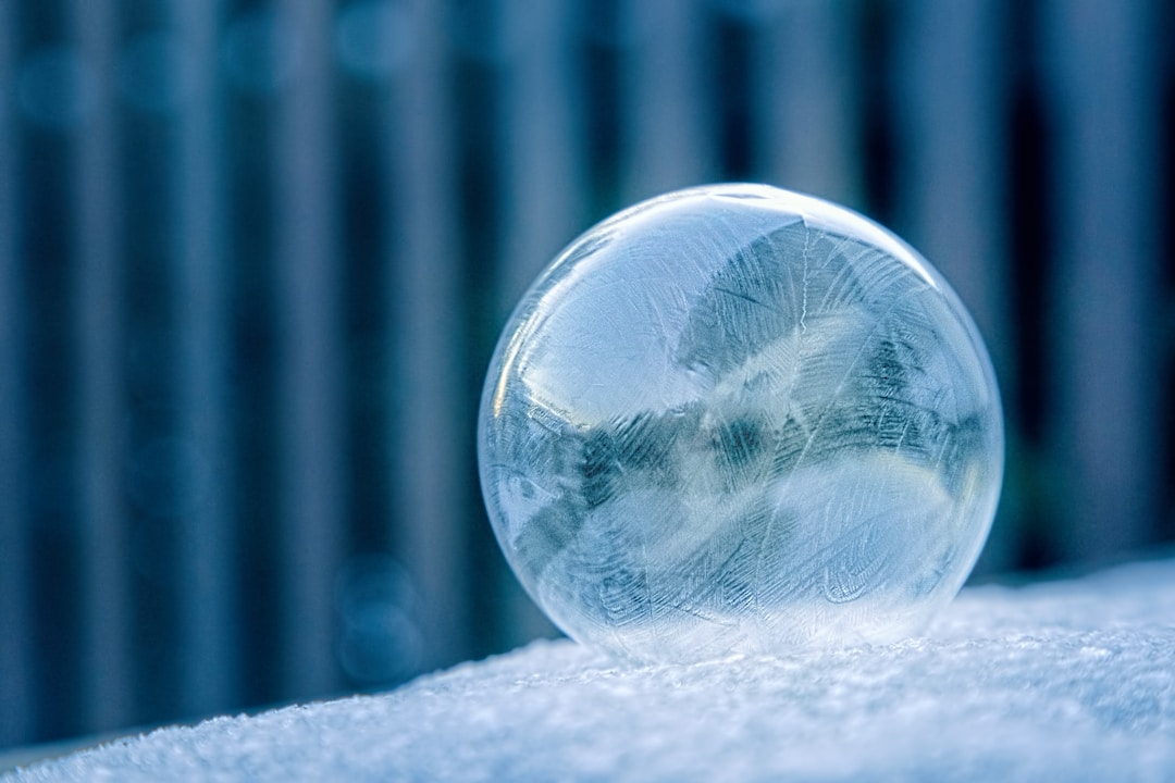 Crystal ball with financial charts reflecting revenue forecasting challenges