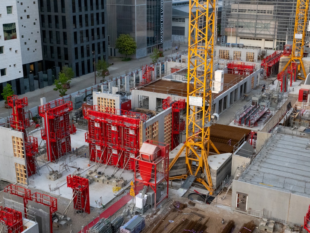 Row of colorful construction hard hats and safety equipment on industrial workbench