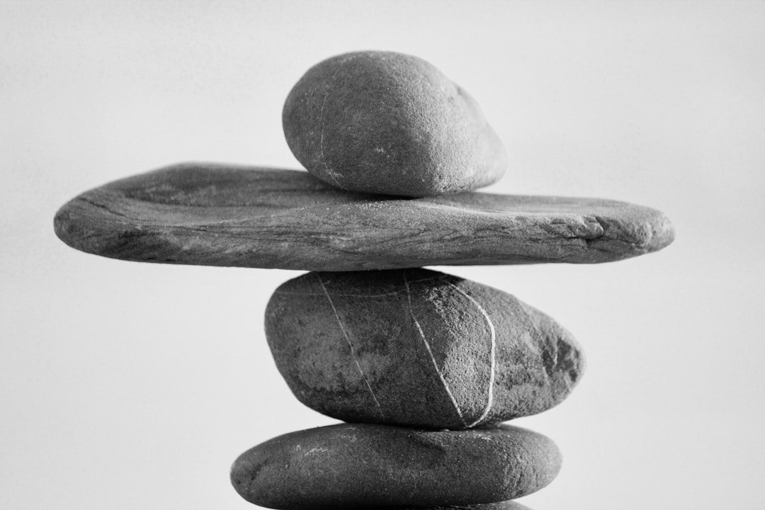 Traditional balance scale with different weights showing valuation comparison methods