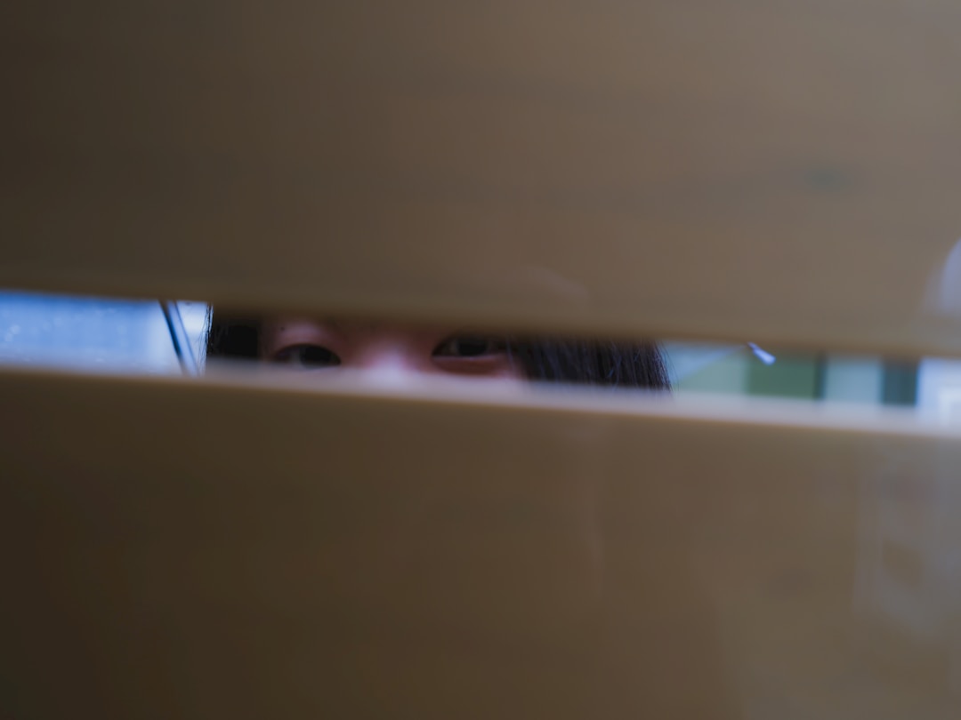 Eye peering through old-fashioned keyhole representing competitor intelligence and observation