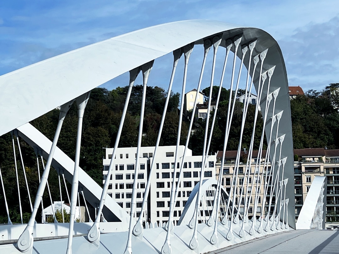 Modern architectural bridge spanning water representing infrastructure connecting two distinct points